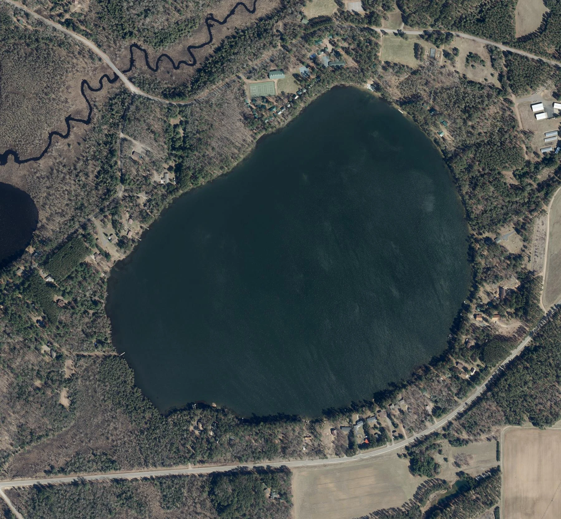 2024 aerial overview of the complete Snowden Lake shoreline and surrounding woods.