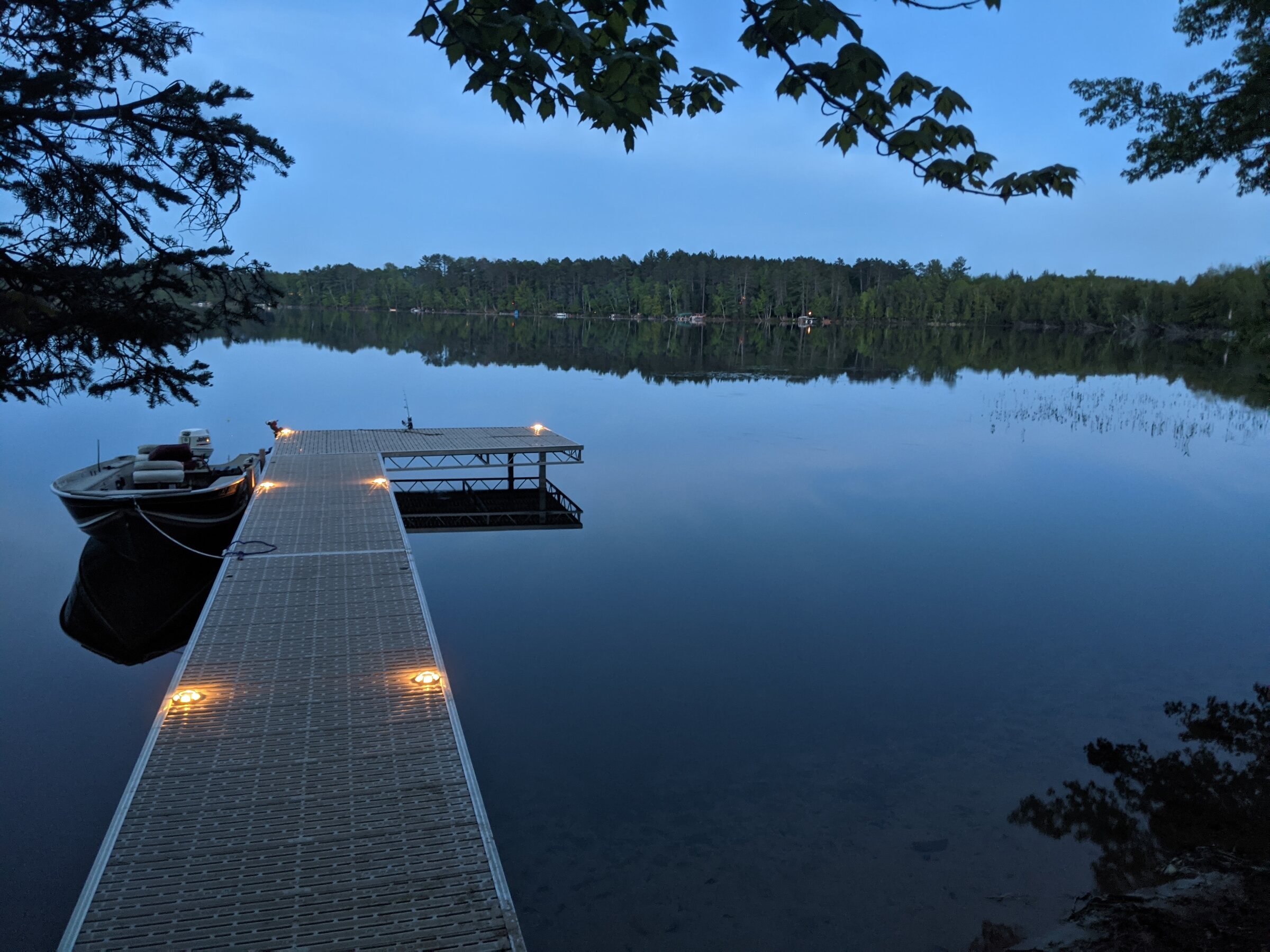 Dock at dusk on calm water