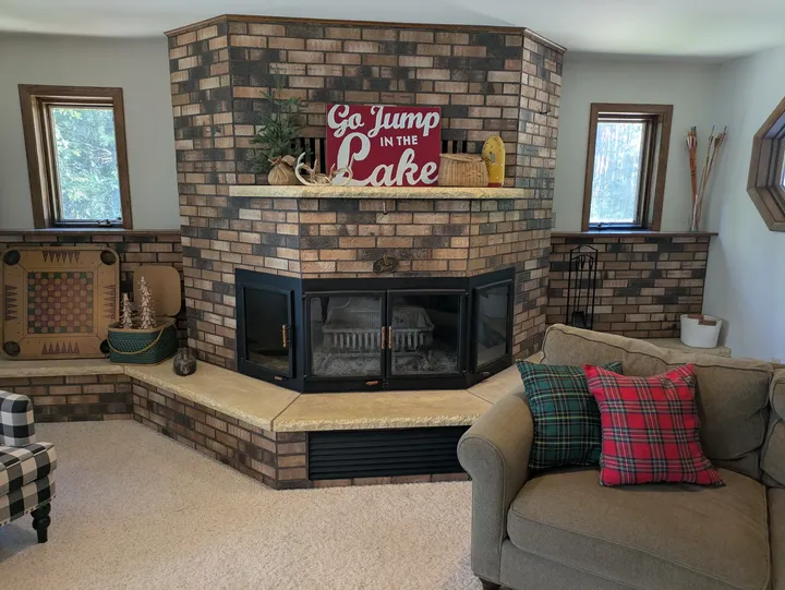 Brick fireplace and hearth at the end of the living room