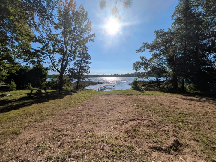 Open lawn sloping toward the pier and Snowden Lake
