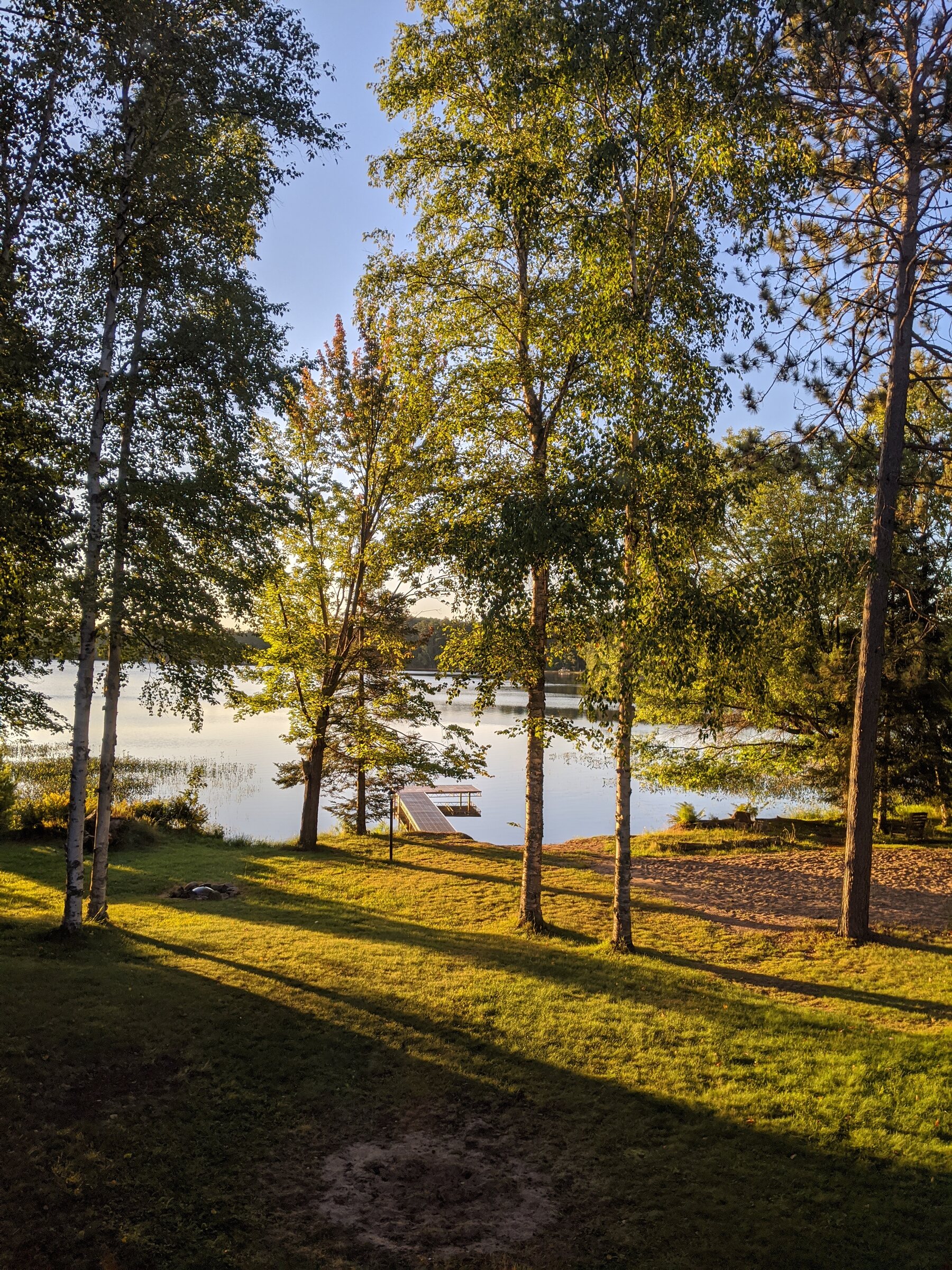 View through mature trees toward the dock and Snowden Lake